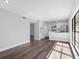 Open-concept living area with wood floors flowing into the kitchen, offering seamless design at 15307 Summerwind Dr, Tampa, FL 33624
