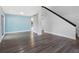 Inviting living room with stairs, laminate floors, and large windows, freshly painted at 15307 Summerwind Dr, Tampa, FL 33624