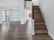 Inviting living room with stairs, laminate floors, and large windows, freshly painted at 15307 Summerwind Dr, Tampa, FL 33624
