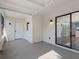 Covered patio with white walls and ceiling, leading to the interior through sliding doors at 15307 Summerwind Dr, Tampa, FL 33624