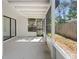 Covered patio featuring white posts and a screen door with a view of the backyard at 15307 Summerwind Dr, Tampa, FL 33624