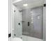 Modern glass enclosed shower featuring gray subway tile, black fixtures, and a white base at 15307 Summerwind Dr, Tampa, FL 33624