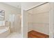 Walk-in closet with multiple racks plus view of large shower with glass door and pink tile at 15324 Sherwood Forest Dr, Tampa, FL 33647