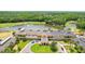 Grand clubhouse with a circular drive and palm trees overlooking a scenic pond and golf course at 15324 Sherwood Forest Dr, Tampa, FL 33647