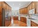 Updated kitchen features stainless steel appliances, light countertops, tile backsplash, and wood cabinets at 15324 Sherwood Forest Dr, Tampa, FL 33647