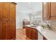 Eat-in kitchen includes wood cabinets, white countertops, modern sink, and hardwood floors at 15324 Sherwood Forest Dr, Tampa, FL 33647