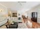Living room with hardwood floors open to dining area with a view of the elegant chandelier at 15324 Sherwood Forest Dr, Tampa, FL 33647