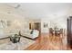 Open-concept living and dining area featuring hardwood floors and neutral decor at 15324 Sherwood Forest Dr, Tampa, FL 33647