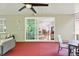 Covered porch offers an indoor and outdoor living experience, complete with ceiling fan and dining area at 15324 Sherwood Forest Dr, Tampa, FL 33647