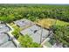 Aerial view of multiple tennis courts surrounded by lush trees and greenery at 15324 Sherwood Forest Dr, Tampa, FL 33647