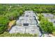 Overhead shot of multiple tennis courts with a net and tall light posts with surrounding trees at 15324 Sherwood Forest Dr, Tampa, FL 33647