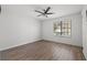 Bright bedroom featuring wood floors, a ceiling fan and a sunny window at 16512 Brigadoon Dr, Tampa, FL 33618
