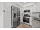 Modern kitchen featuring stainless steel appliances and sleek white cabinetry at 16512 Brigadoon Dr, Tampa, FL 33618