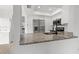 Modern kitchen featuring granite countertops, stainless steel appliances, and white cabinets at 16512 Brigadoon Dr, Tampa, FL 33618