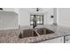 Stylish kitchen featuring granite countertops and stainless steel sink at 16512 Brigadoon Dr, Tampa, FL 33618