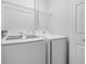 Laundry area featuring modern washer and dryer with overhead wire shelving at 16512 Brigadoon Dr, Tampa, FL 33618