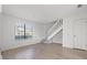Bright living room features wood floors, large window, and staircase access at 16512 Brigadoon Dr, Tampa, FL 33618