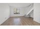 Well-lit living room with stairs and new flooring at 16512 Brigadoon Dr, Tampa, FL 33618