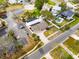 Expansive aerial view showing home, screened pool, solar panels, brick driveway, lush landscaping, and nearby parking lot at 1820 Massachusetts Ne Ave, St Petersburg, FL 33703