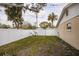 Fenced backyard featuring a well maintained lawn and tropical landscaping at 1820 Massachusetts Ne Ave, St Petersburg, FL 33703