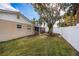Well-maintained backyard featuring green grass, screened-in porch, and a privacy fence at 1820 Massachusetts Ne Ave, St Petersburg, FL 33703