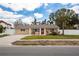Charming single-story home with a well-maintained lawn, palm trees and a brick driveway at 1820 Massachusetts Ne Ave, St Petersburg, FL 33703