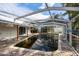 Enclosed pool area with brick pavers, covered patio, and clear panels to enjoy outdoor scenery at 1820 Massachusetts Ne Ave, St Petersburg, FL 33703