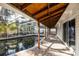 Outdoor enclosed pool area featuring brick pavers, a covered patio, and lush tropical landscaping at 1820 Massachusetts Ne Ave, St Petersburg, FL 33703