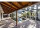 Outdoor enclosed pool area with brick pavers, covered patio, and a clear view of backyard foliage at 1820 Massachusetts Ne Ave, St Petersburg, FL 33703