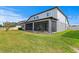 Exterior of home showing the screened-in lanai and large grassy backyard at 19204 Briarbrook Dr, Tampa, FL 33647