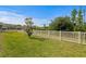 Grassy backyard featuring a white picket fence at 19204 Briarbrook Dr, Tampa, FL 33647