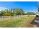 Large grassy backyard with a crisp white picket fence at 19204 Briarbrook Dr, Tampa, FL 33647