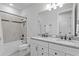 Elegant bathroom with double granite vanity and modern tiled shower with black matte fixtures at 19204 Briarbrook Dr, Tampa, FL 33647