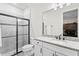 Bathroom featuring a walk-in shower and granite vanity top with modern fixtures at 19204 Briarbrook Dr, Tampa, FL 33647