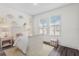 Charming bedroom with two sunny windows, cloud wall decorations, and a white bed frame at 19204 Briarbrook Dr, Tampa, FL 33647