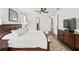 Bright bedroom with a king bed, wood floors, and closet/bathroom entrances at 19204 Briarbrook Dr, Tampa, FL 33647