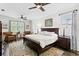 Cozy bedroom with a dark wood king-size bed, elegant rug, and bedside tables with lamps at 19204 Briarbrook Dr, Tampa, FL 33647