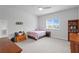 Cozy bedroom with a plush bed, a wooden chest, and a bright window at 19204 Briarbrook Dr, Tampa, FL 33647