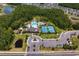 An aerial perspective of the community amenities, including a pool, tennis courts, playground, and clubhouse at 19204 Briarbrook Dr, Tampa, FL 33647