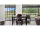 Cozy dining area with views of the screened lanai and backyard through large sliding glass doors at 19204 Briarbrook Dr, Tampa, FL 33647