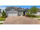 Charming single-Gathering home with a three car garage and brick paver driveway, situated in a well-kept neighborhood at 19204 Briarbrook Dr, Tampa, FL 33647
