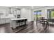 Modern kitchen boasts an island with seating, sleek appliances, and an adjacent dining area bathed in natural light at 19204 Briarbrook Dr, Tampa, FL 33647