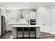 Kitchen with white cabinets, stainless steel appliances, and a central island with bar stool seating at 19204 Briarbrook Dr, Tampa, FL 33647