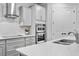Elegant kitchen with stainless steel appliances, ample counter space, white cabinets and subway tile backsplash at 19204 Briarbrook Dr, Tampa, FL 33647