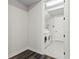Functional laundry room with modern washer and dryer, tiled floors, and white painted door at 19204 Briarbrook Dr, Tampa, FL 33647