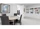 Open-concept living room with custom built-in shelving and a dining area at 19204 Briarbrook Dr, Tampa, FL 33647