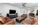 Cozy living room with hardwood floors, ceiling fan and comfortable leather furniture, perfect for entertaining guests at 19204 Briarbrook Dr, Tampa, FL 33647