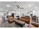 Spacious living room featuring a leather furniture set, ceiling fan, and dark wood flooring at 19204 Briarbrook Dr, Tampa, FL 33647