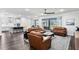 Bright open-concept living area with a ceiling fan and adjacent to a modern kitchen with stainless steel appliances at 19204 Briarbrook Dr, Tampa, FL 33647