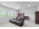 Spacious living area with a leather sofa, bright windows, and built-in bookshelves at 19204 Briarbrook Dr, Tampa, FL 33647